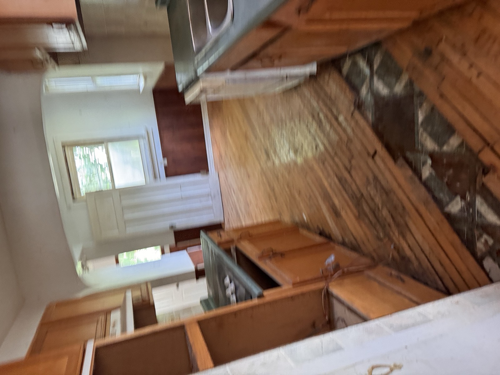 Original 1970s kitchen with worn hardwood floors